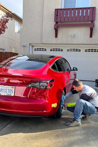 Red Tesla exterior detail with wheel ceramic coating application - mobile service San Jose