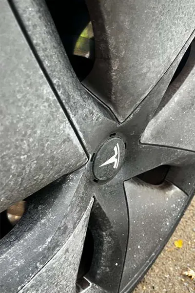 Water spot removal service on tesla rims before picture